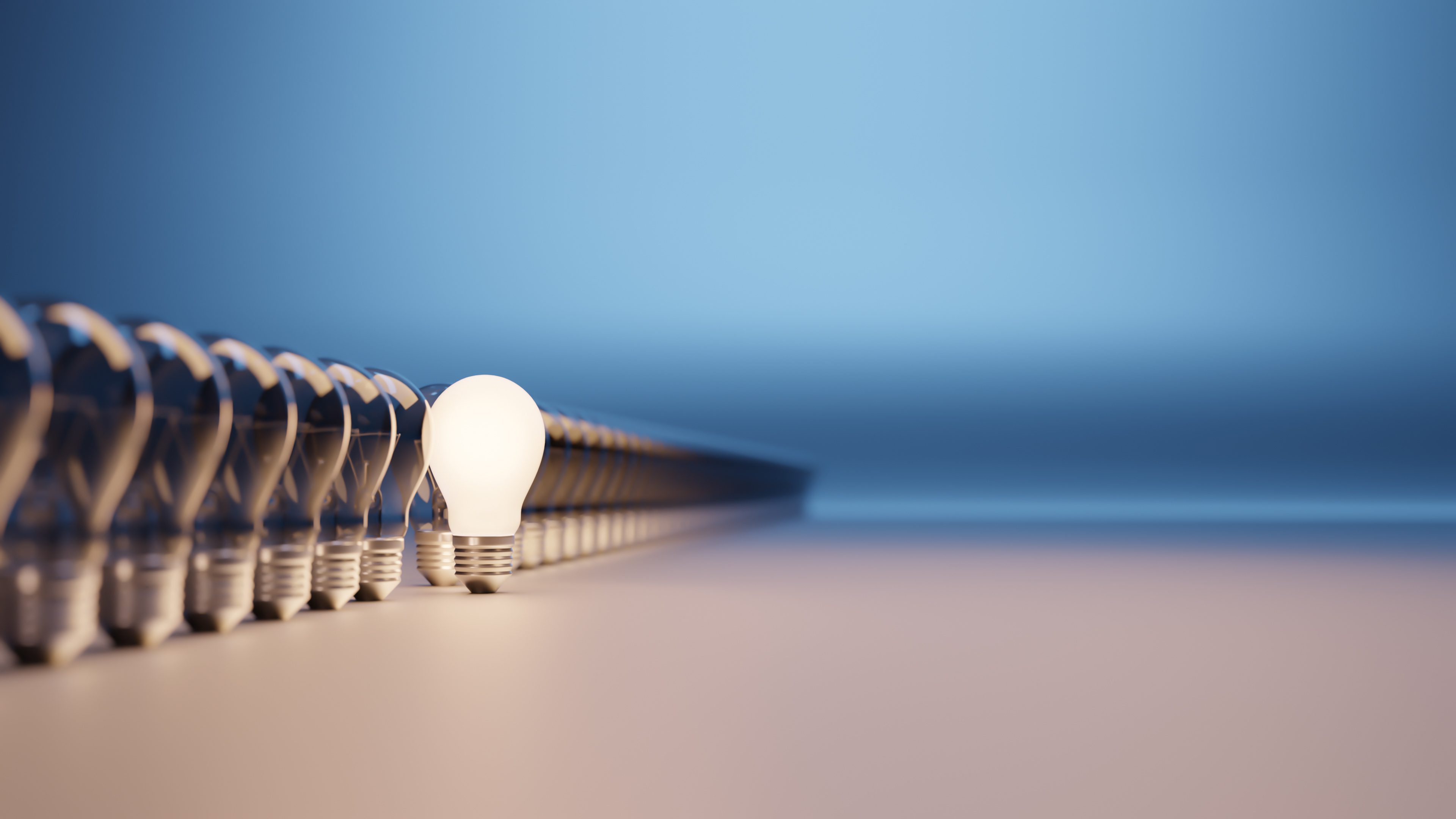 Lights bulbs in a row with one lit and with room for text Lights bulbs in a row with one lit and with room for text